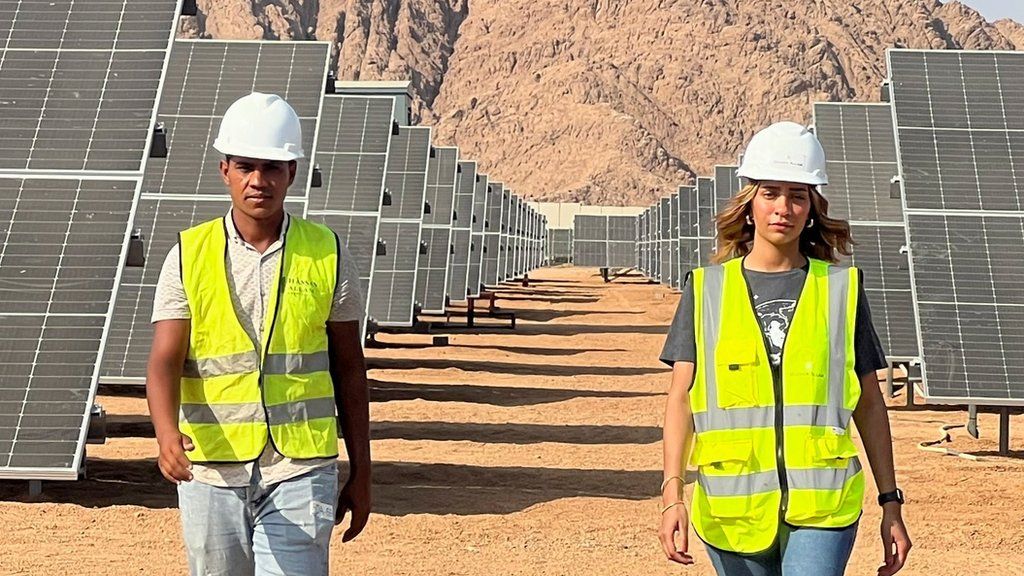 Two people on a solar farm in Egypt