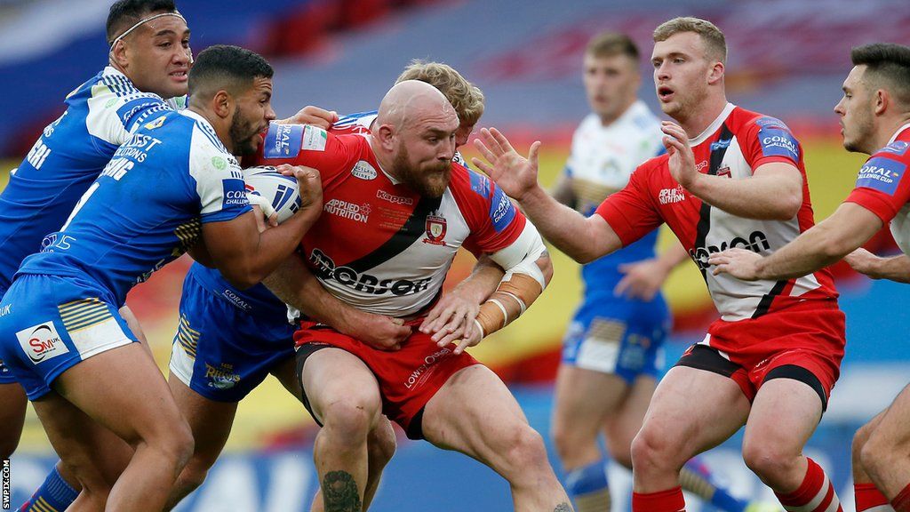 Gil Dudson (centre) tackled by Leeds players in the 2020 Challenge Cup final at Wembley for Salford
