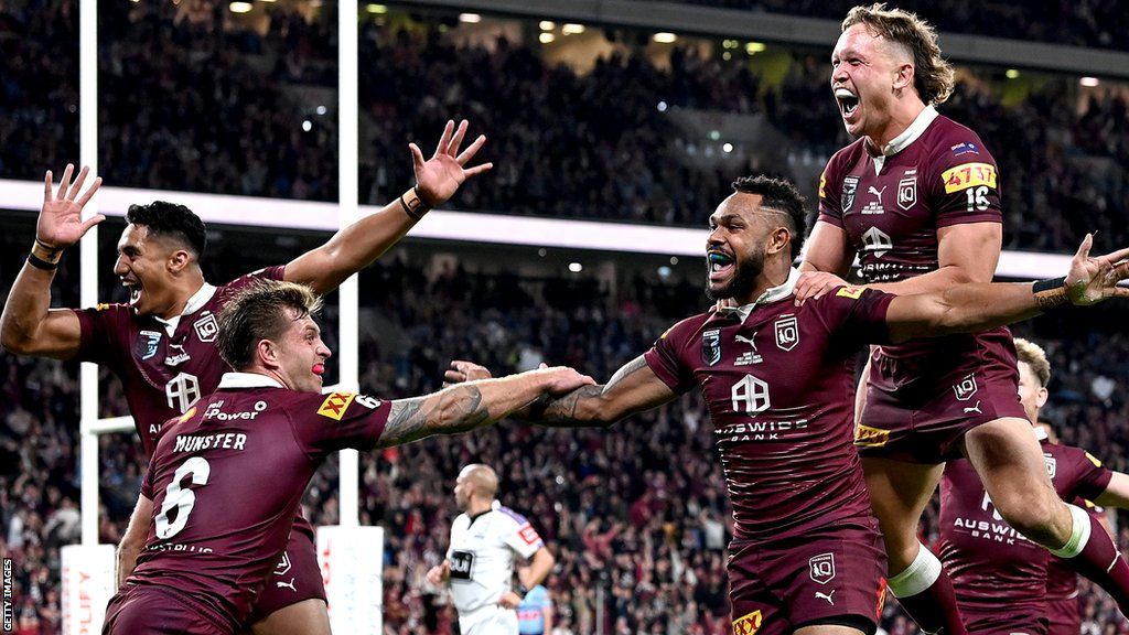 Hamiso Tabuai-Fidow celebrates his try with Queensland team-mates to establish an 18-0 lead