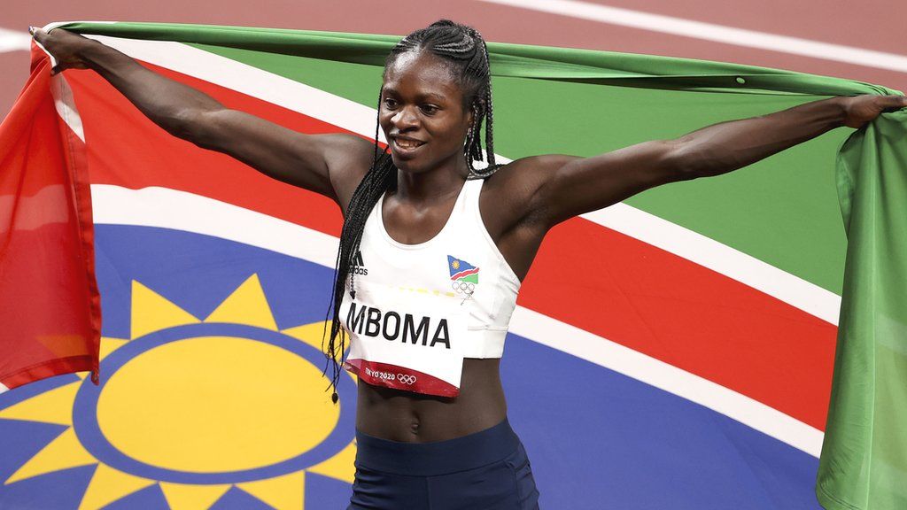 Christine Mboma poses with a Namibian flag as she celebrates winning an Olympic silver medal in the 200m at the Tokyo 2020 Games
