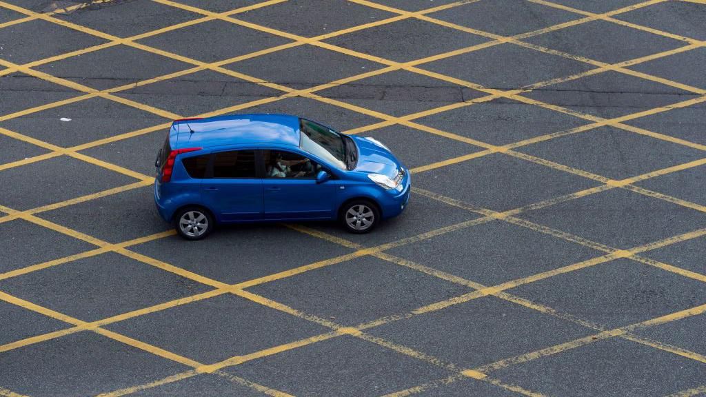 A car in a yellow box junction