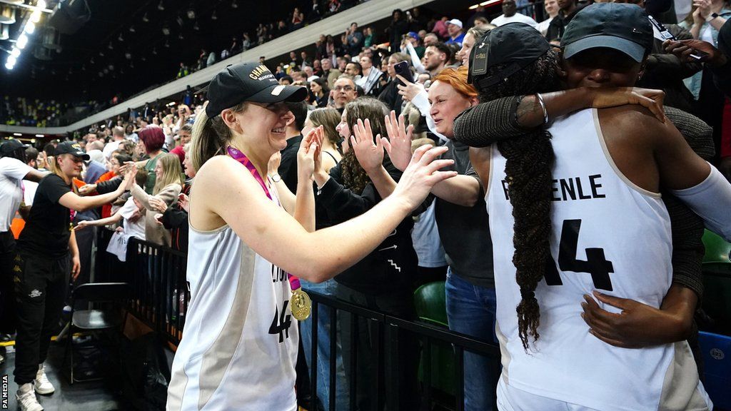 London Lions players Karlie Samuelson and Temi Fagbenle celebrate with people in the crowd