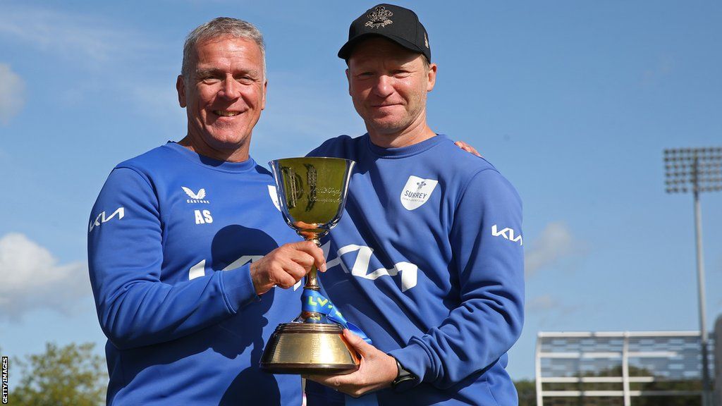 Surrey director of cricket Alec Stewart and head coach Gareth Batty hold the 2023 County Championship trophy