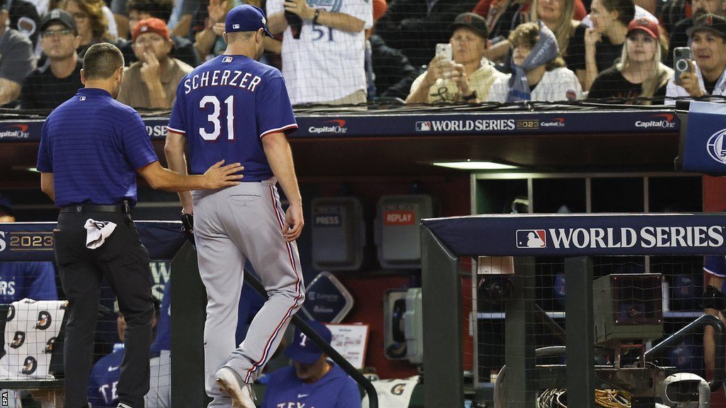 Texas Rangers pitcher Max Scherzer leaves the field with a back injury