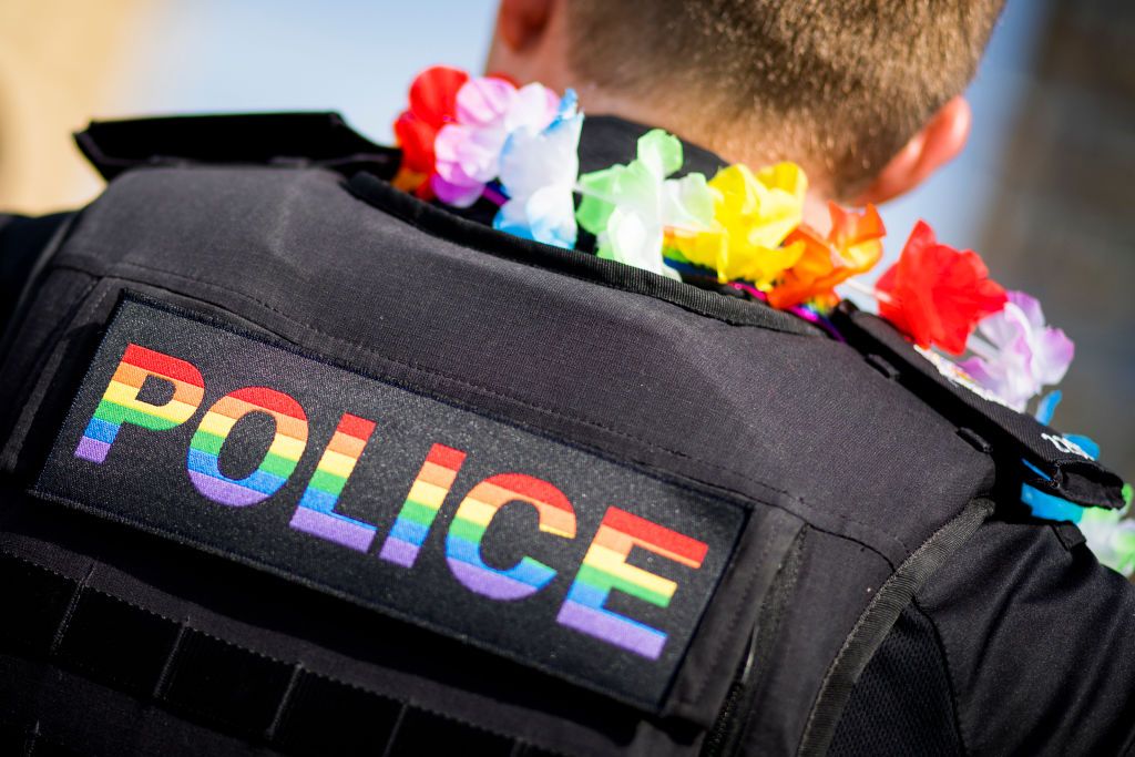 A police officer with a rainbow jacket and garland, at Brighton pride last year