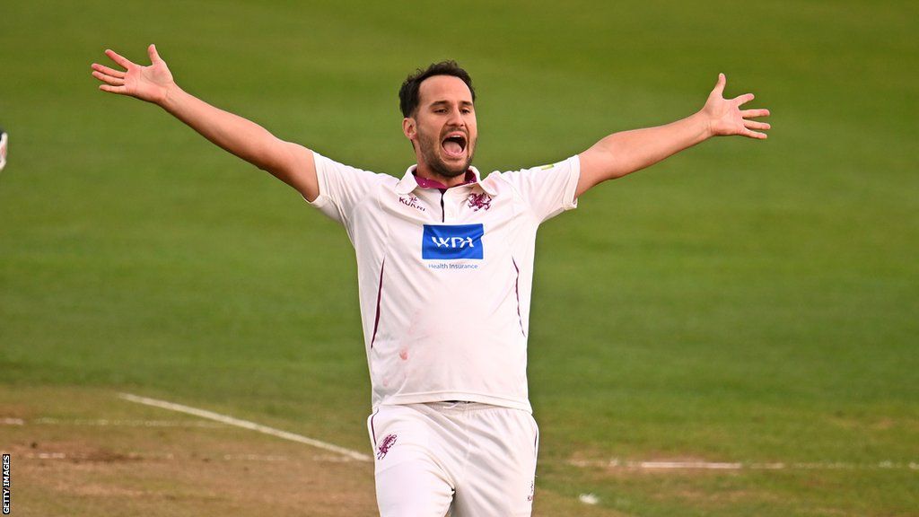 Lewis Gregory holds his arms out as he celebrates a wicket during the 2023 County Championship