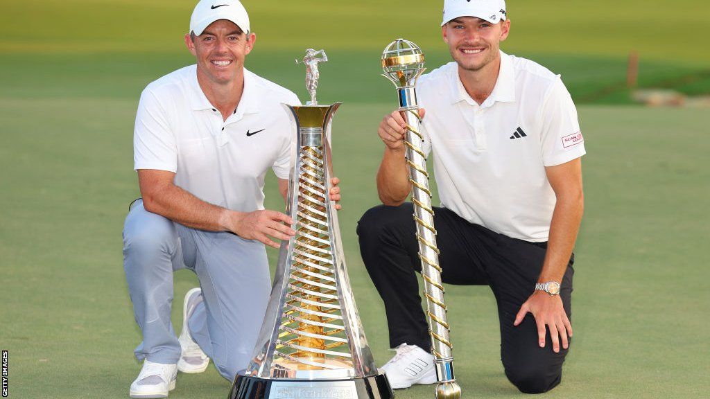 Rory McIlroy and Nicolai Hojgaard with their respective Race to Dubai and DP World Tour Championship trophies