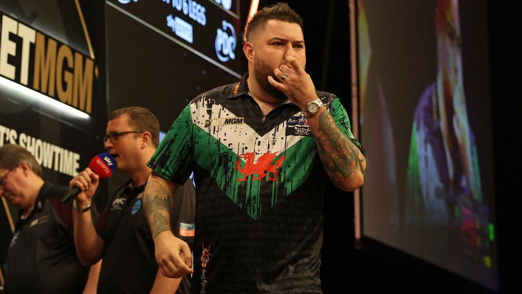 Michael Smith reacts by whistling back at those in the crowd trying to put him off after his victory against England's Luke Littler