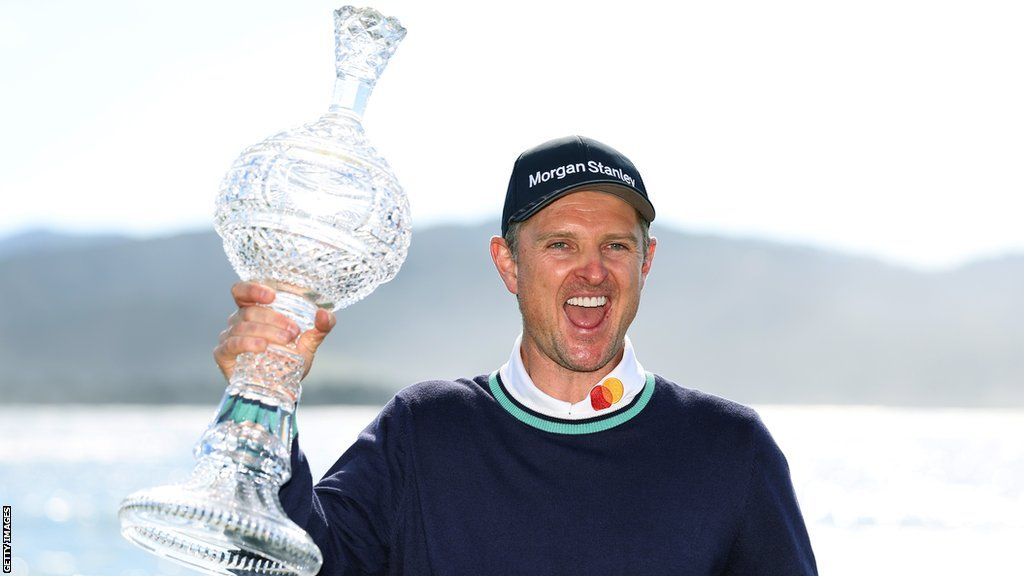 Justin Rose holds up the trophy in celebration after winning the Pebble Beach Pro-Am