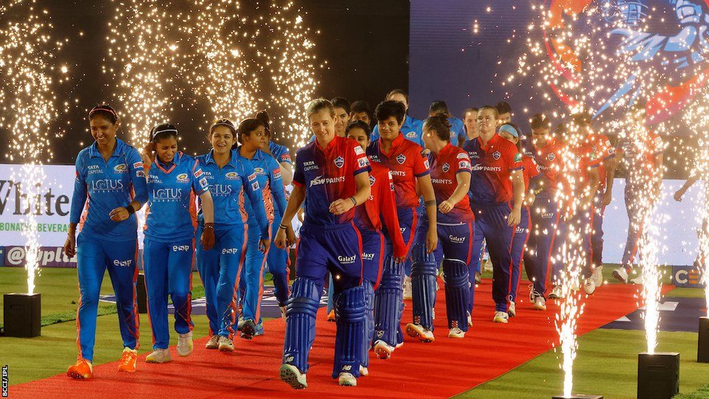 Mumbai Indians and Delhi Capitals walk on to the field for the WPL final with fireworks around them