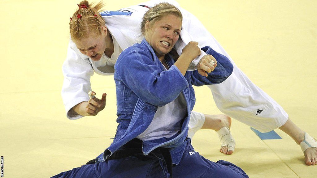 Ronda Rousey throws her opponent during a judo bout at the Olympics