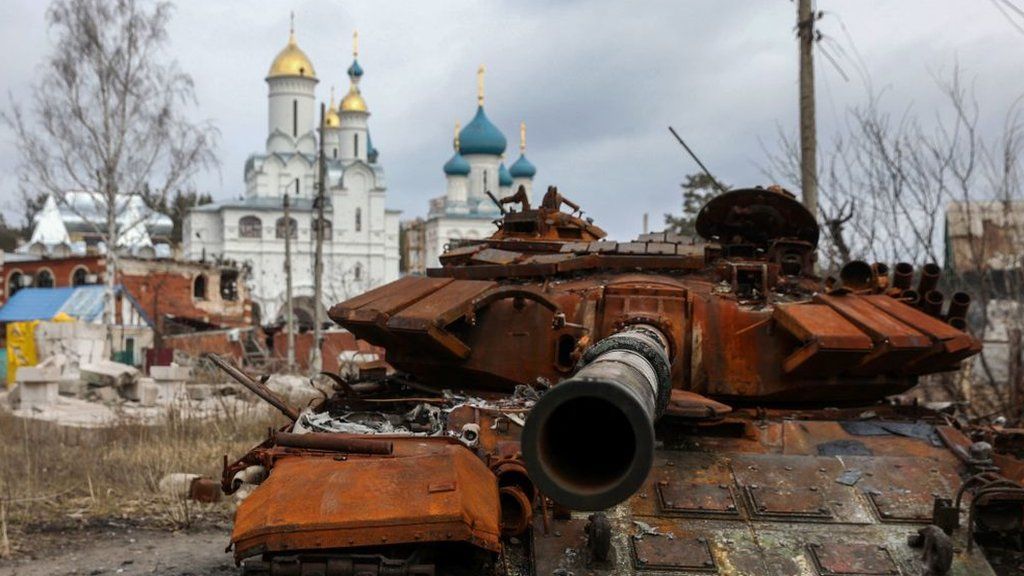 A destroyed Russian tank near a church in the city of Sviatohirsk, Donetsk