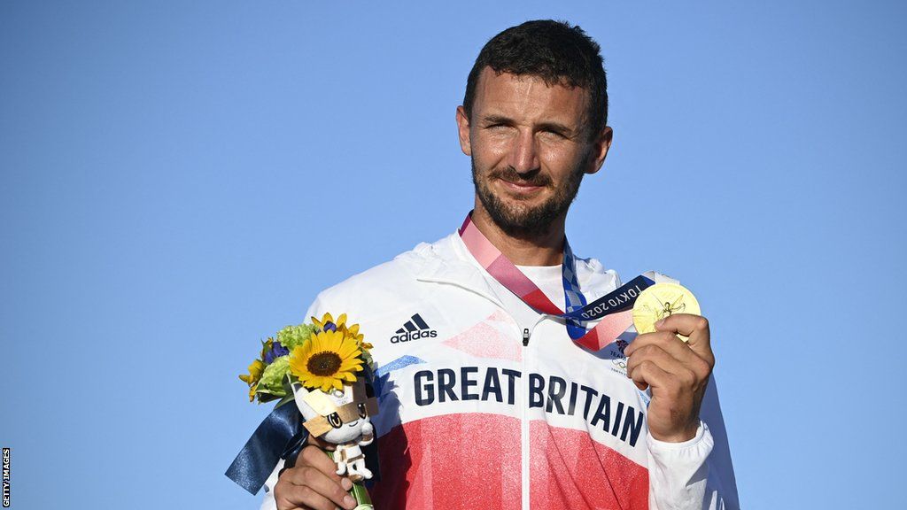 Giles Scott shows off an Olympic gold medal