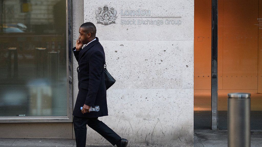 Man walks past London stock exchange