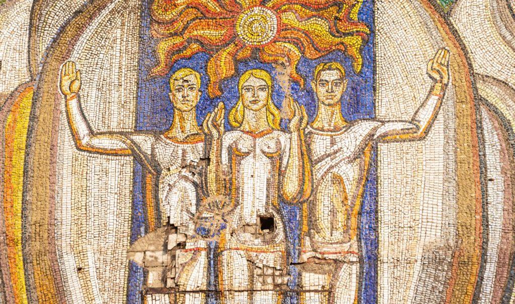 A mosaic picturing three strong youths