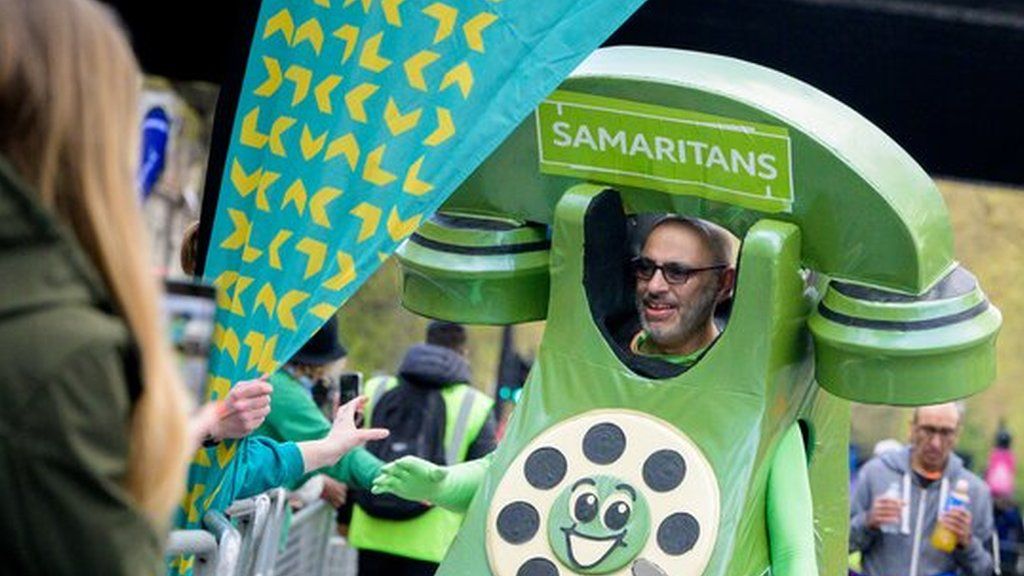 Dave Lock running in his green telephone costume