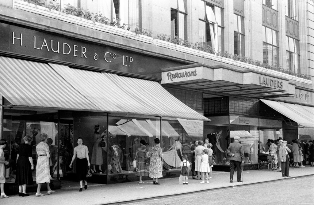 Shoppers outside Hugh Lauder and Co. in the Scottish town of Kilmarnock. Kilmarnock has over a thousand shops including branches of national chain stores and well-established old family businesses such as this particularly popular department store. 