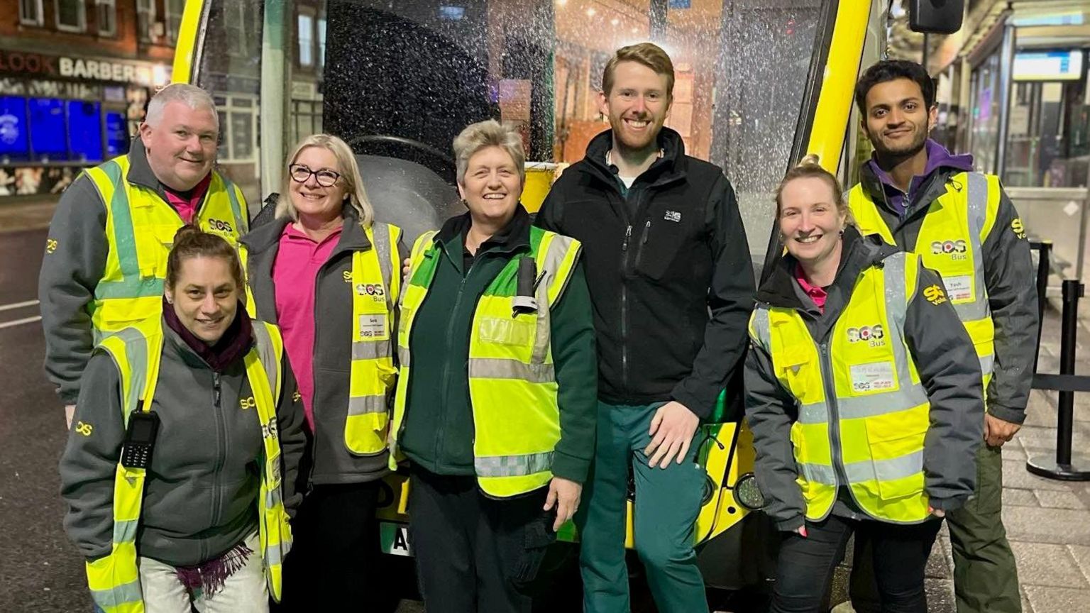 Volunteers and paid staff stood outside the SOS Bus