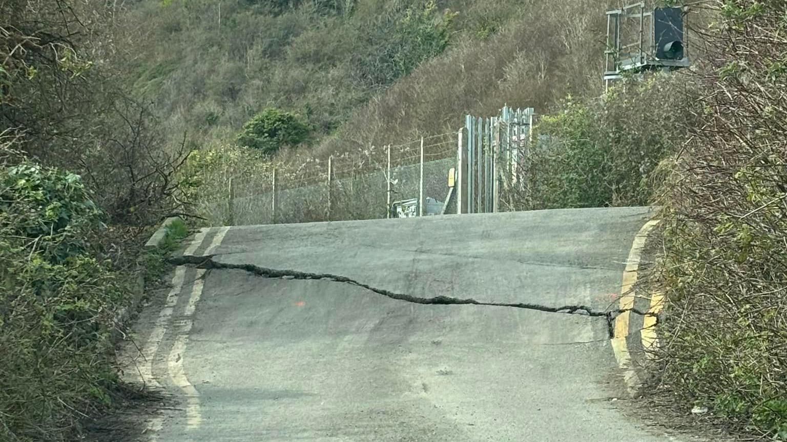 Huge crack stretches across width of road at Folkestone Warren