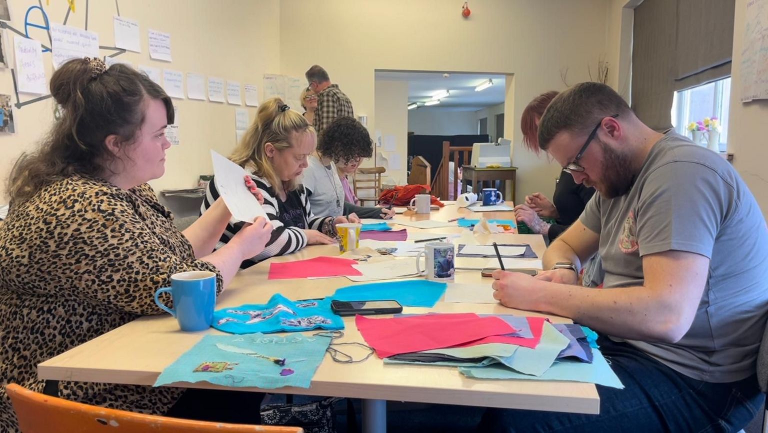 The Social Agency members designing their individual textile squares for the banner