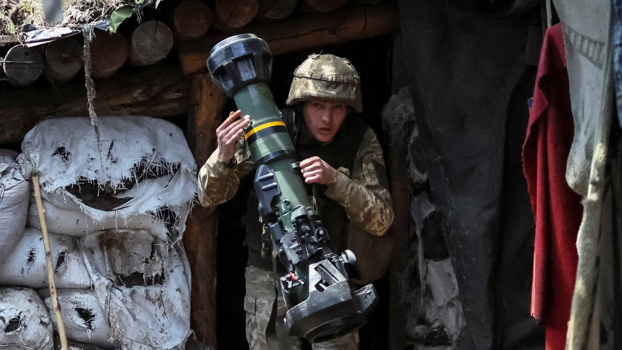 A Ukranian service member holding a next generation light anti-tank weapon (NLAW) near the front line