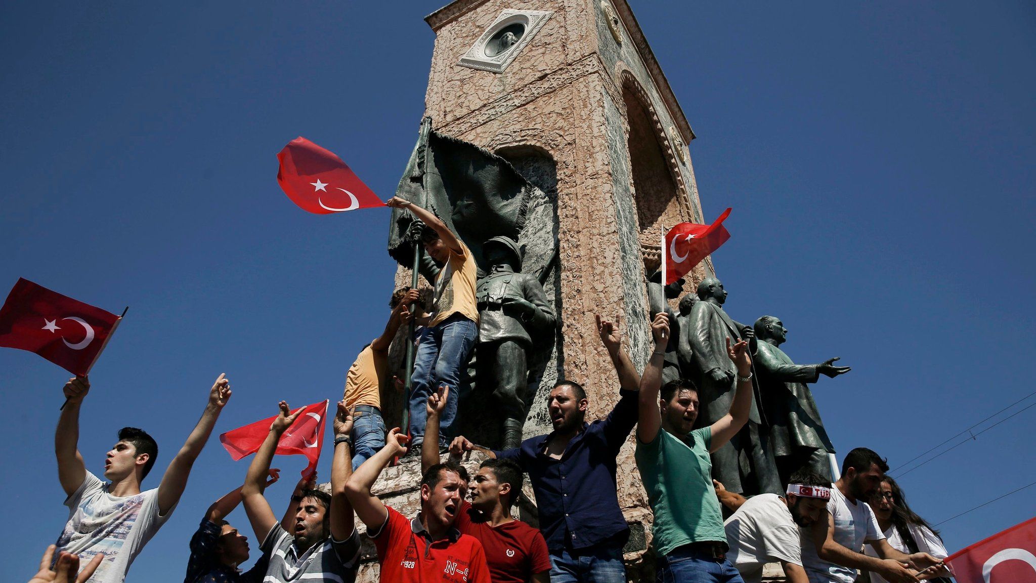 People gathered on a monument in Taksim Square