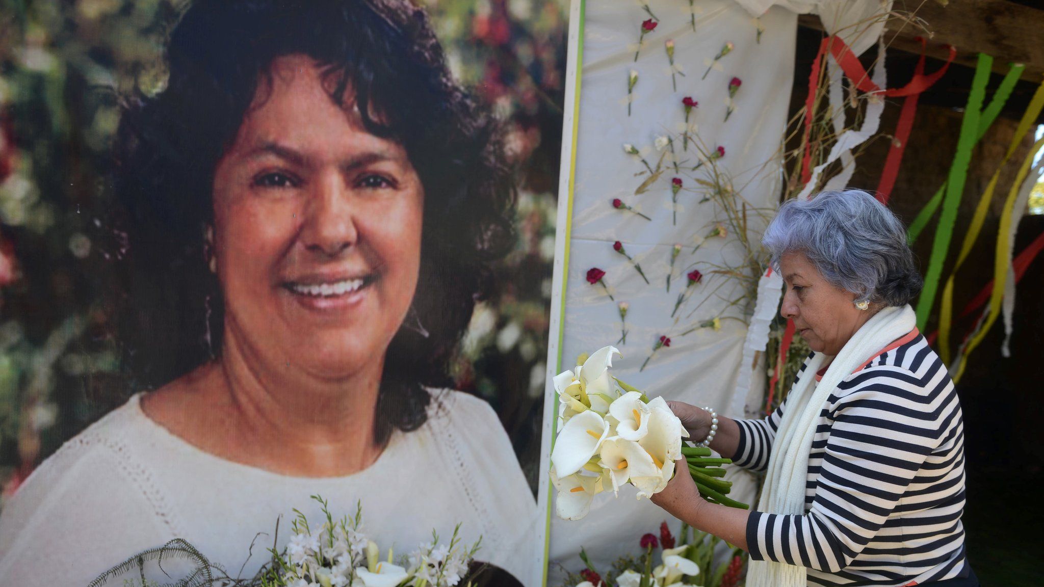 The president of the NGO Committee of Relatives of the Disappeared in Honduras (COFADEH), Bertha Oliva, lays a wreath on an alter in memory of murdered indigenous Honduran environmentalist Berta Caceres, in La Esperanza,