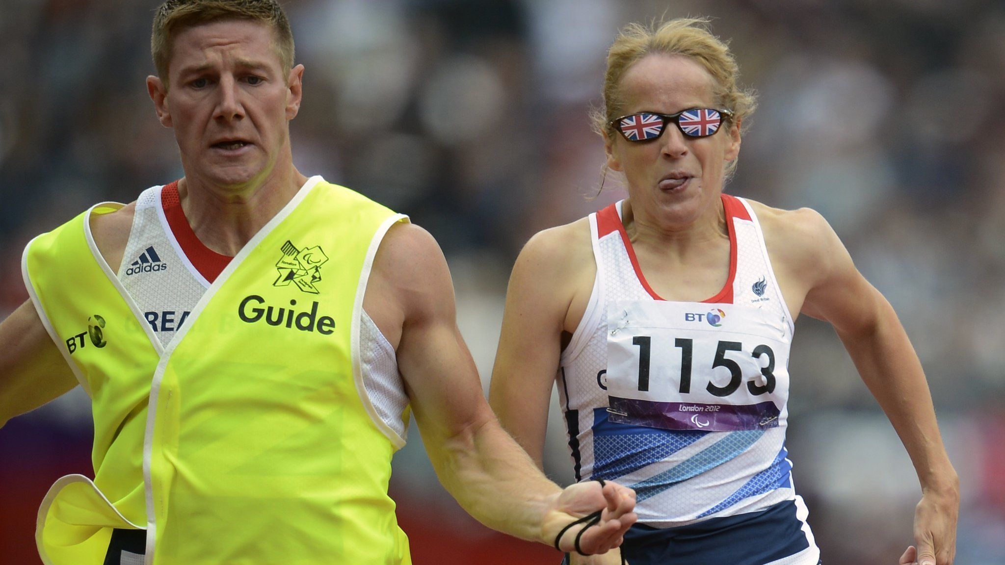 Tracey Hinton runs with her guide Steffan Hughes during the women's 200m T11 semi-finals at the London 2012 Paralympic Games