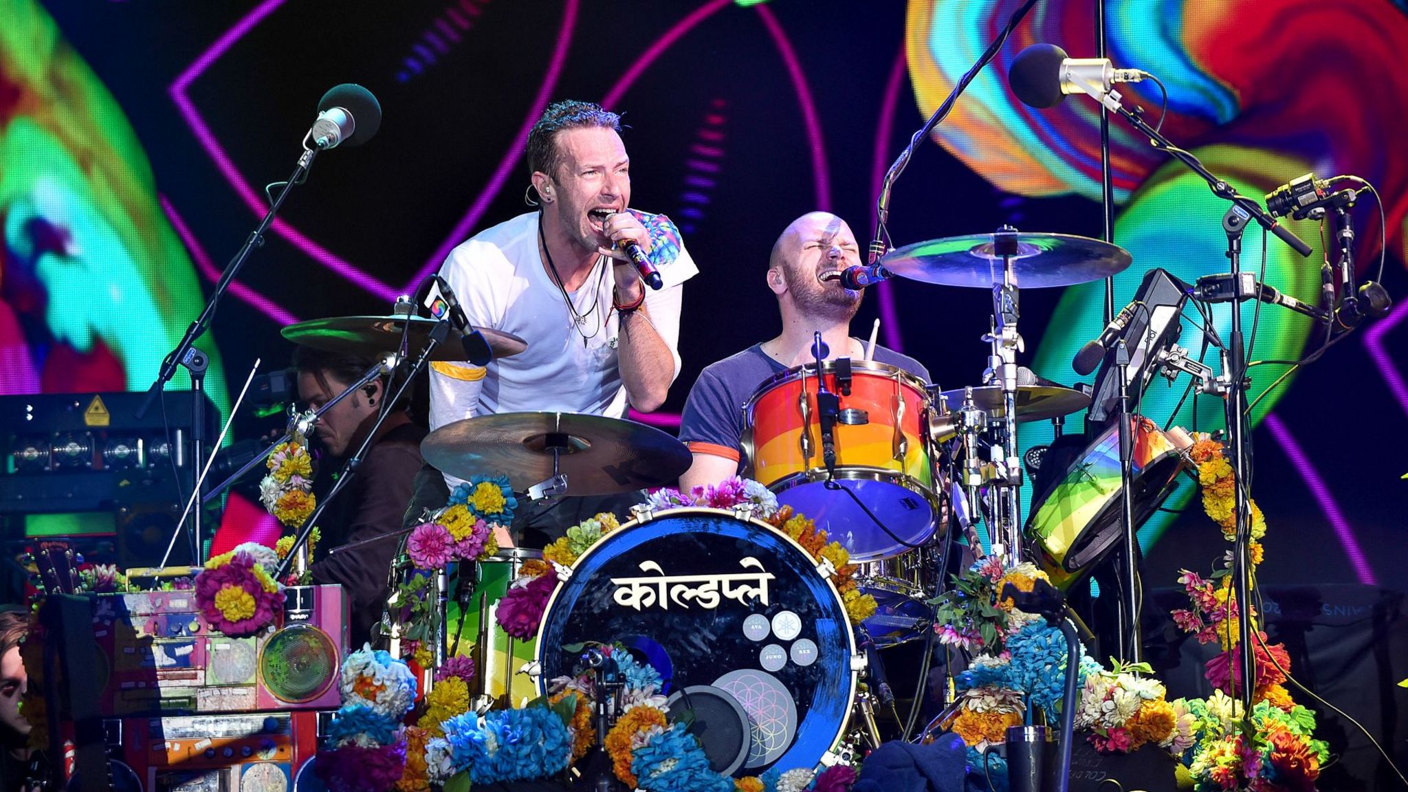 Coldplay performing on stage