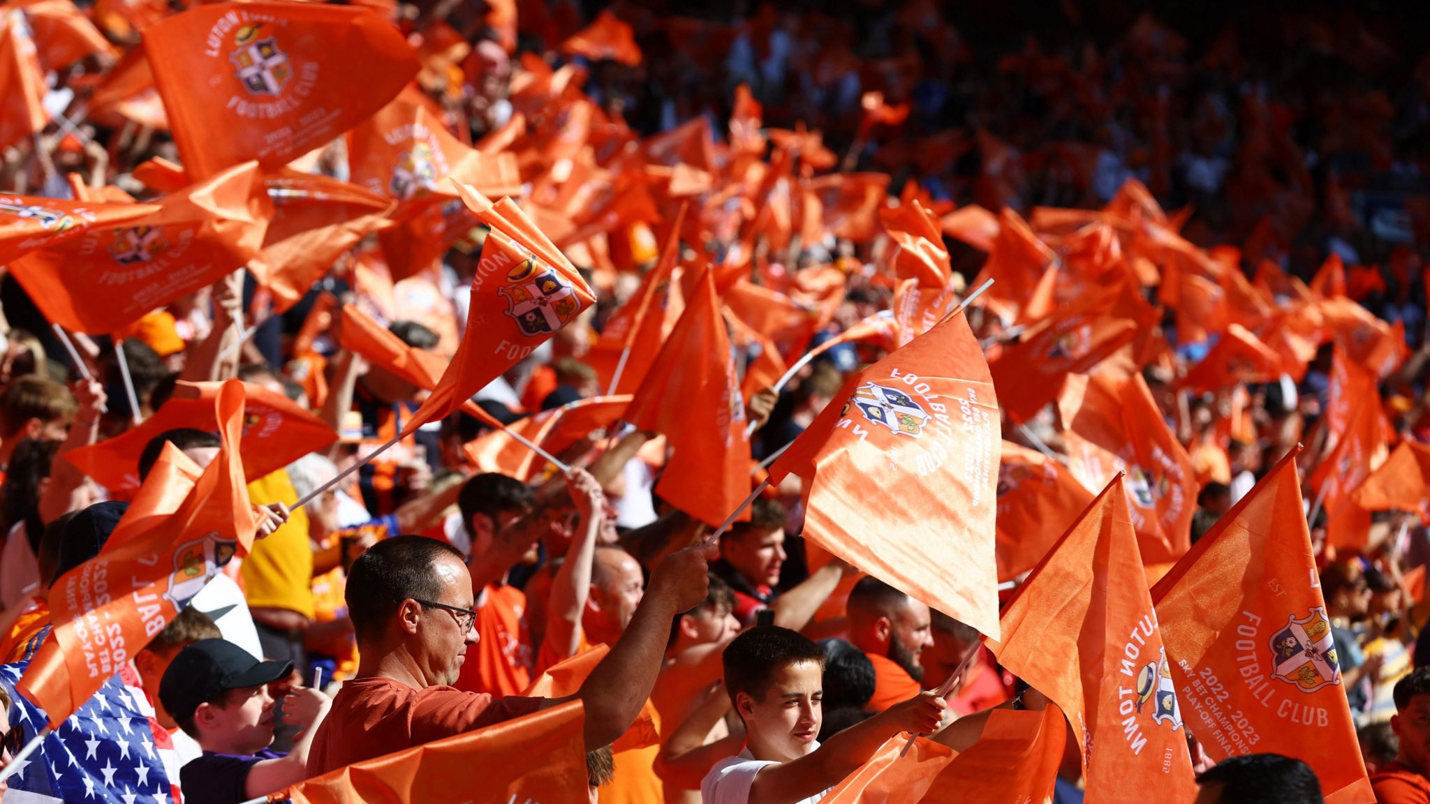 Orange banners and flags flown by Luton fans in the stands of Wembley