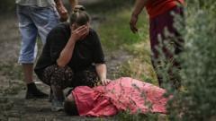 A woman mourns over the body of her relative who was reportedly killed by a cluster rocket in the city of Lysychansk in the eastern Ukrainian region of Donbas on June 18, 2022 amid the Russian invasion of the country.