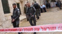 Israeli security officials stand behind tape at crime scene