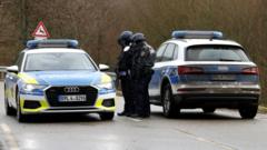 German police secure the road after the shooting of two officers in western Germany