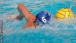 Young man playing water polo