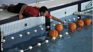 Volunteer arranging water polo balls after training session