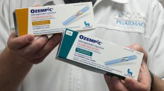 A pharmacist displays boxes of Ozempic, a semaglutide injection drug used for treating type 2 diabetes