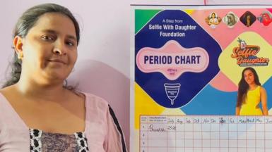 A woman poses with her Period Chart