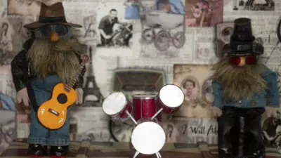 Два бородатых гномика-музыканта сделанных из мусора и старой одежды