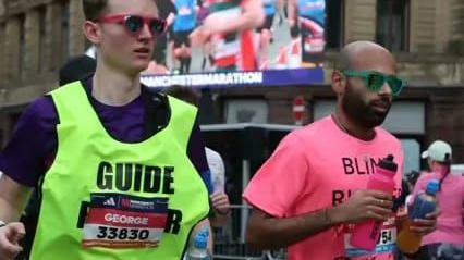 Yahya runs the marathon alongside his guide