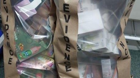 two evidence sacks of illegal vapes