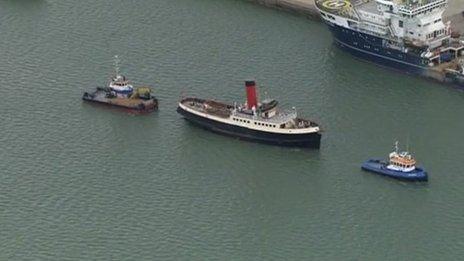 The tug Calshot leading a flotilla away from berth 44 where Titanic was