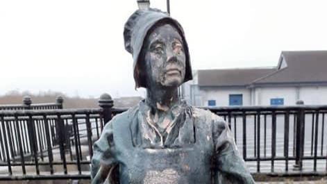 Statue of a woman with paint daubed on it