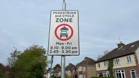 A pedestrian and cycle zone sign