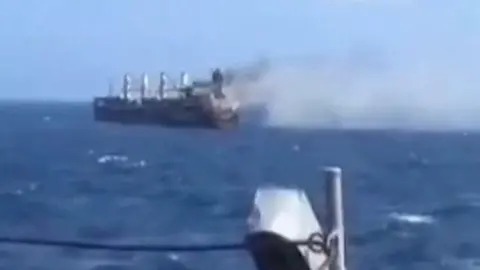 Smoke coming off ship in the sea