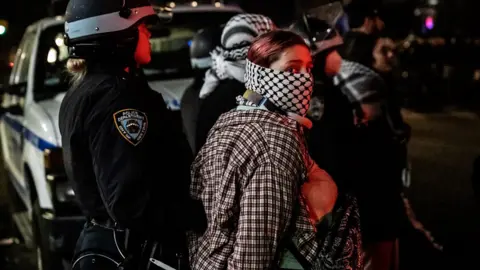 Woman being held by police