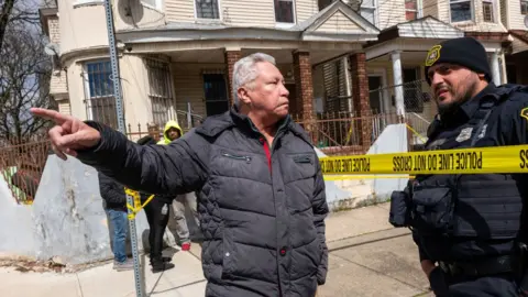 Residents and police gather outside of homes that were structurally damaged and had to be evacuated after New York City and parts of New Jersey experienced a 4.8 magnitude earthquake on April 05, 2024 in Newark, New Jersey.