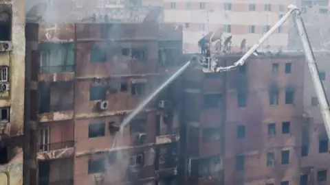 Water being sprayed on a burning building