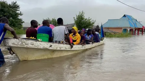 People being rescued in a canoe in Rufiji district in Coastal region earlier this month