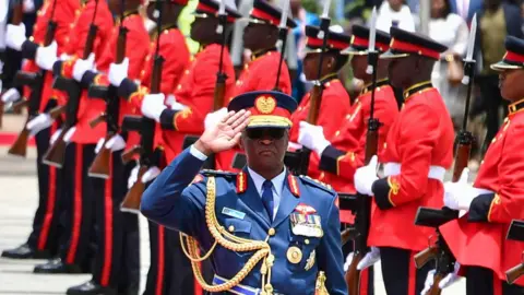 Chief of Kenya Defence Forces General Francis Ogolla (C) gestures as Britain's King Charles III (unseen) and Kenyan President William Ruto (unseen) arrive at the tomb of the Unknown Warrior during a wreath laying ceremony at Uhuru Gardens in Nairobi on October 31, 2023.