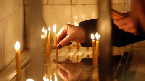 A person lighting up candles